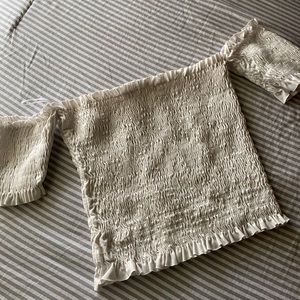 A white over the shoulder crop top